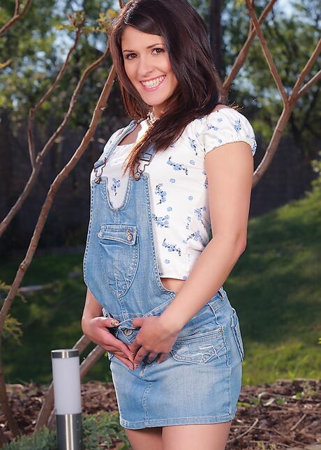 Attractive hungarian brunette young Connie Berry exposes her butt in fancy skirt and toys her twat outdoor